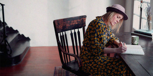 Woman writing at desk | Readable, free readability test