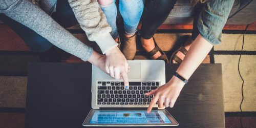 Professional Writing, Laptop image with multiple users gathered round